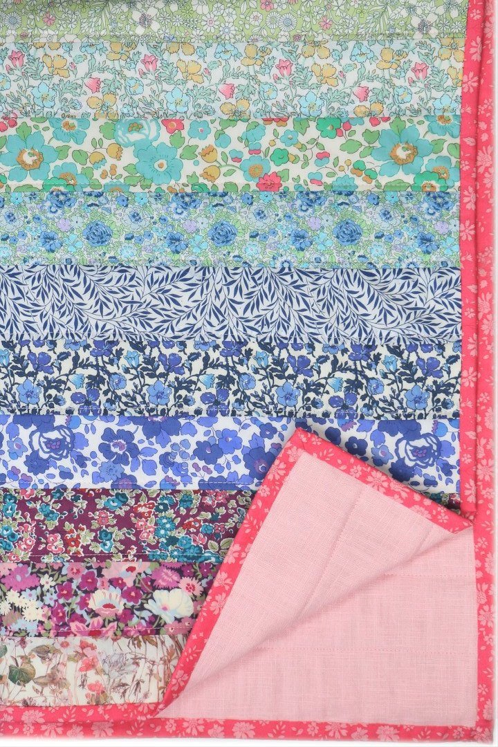 Liberty fabric rainbow patchwork quilt. Perfect nursery bedcover or new baby gift