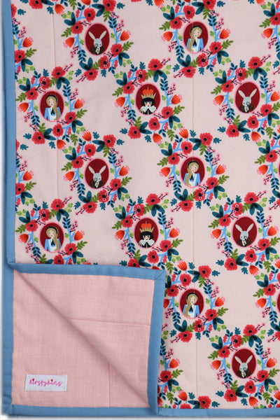 Handmade blanket with pink rifle paper fabric and blue handsewn binding